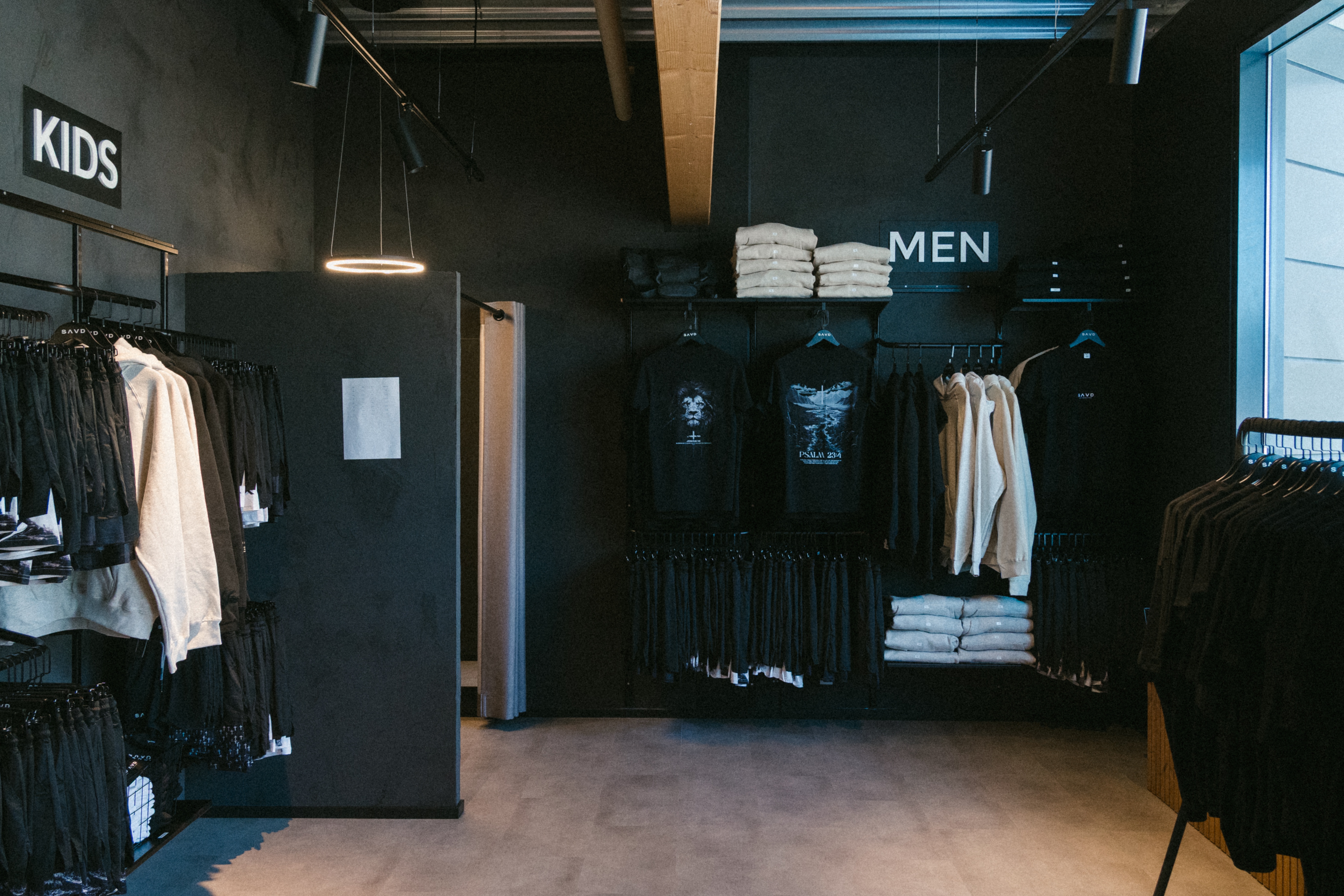 SAVD Clothing store interior showing clothing racks and Kids and Men sections