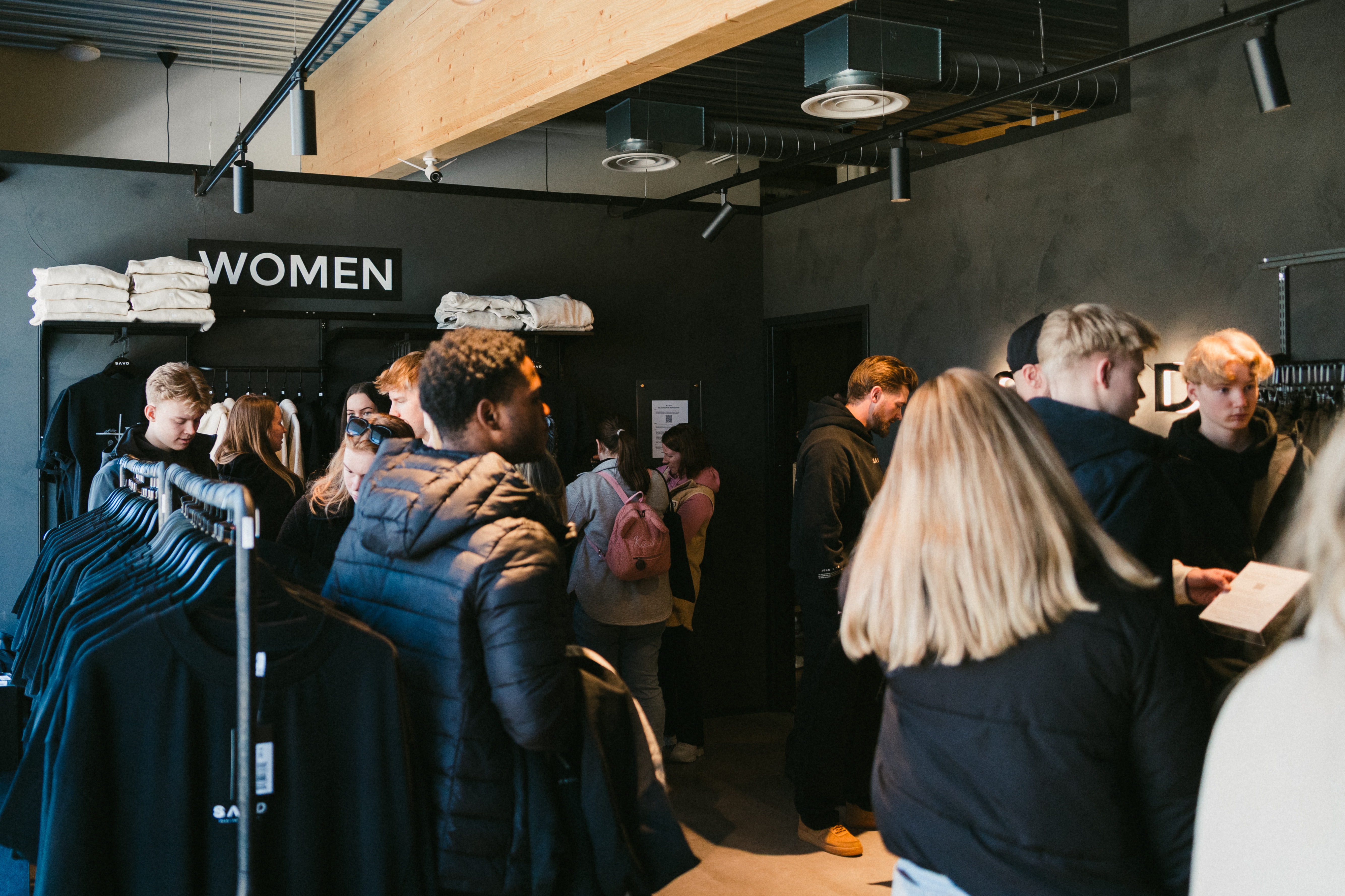 Busy SAVD Clothing store full of customers shopping independently